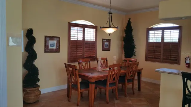 a view of a dining room with furniture and window