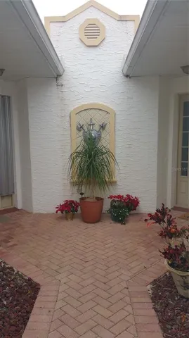 a vase of flowers sitting on a floor