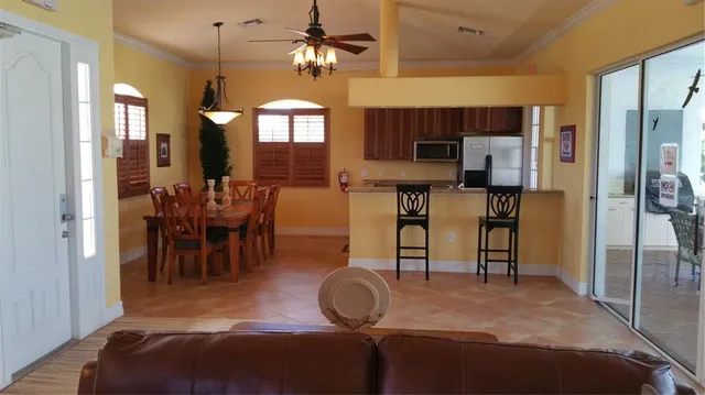a view of a dining room with furniture a chandelier and wooden floor
