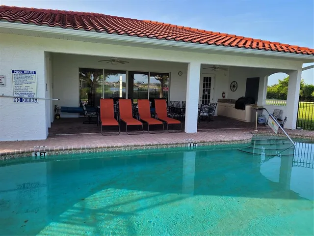 a view of an house with backyard porch and furniture