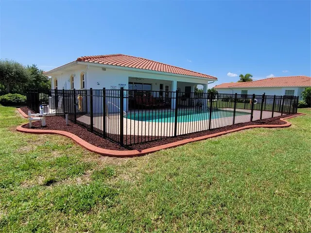 a view of a house with a yard balcony and sitting area