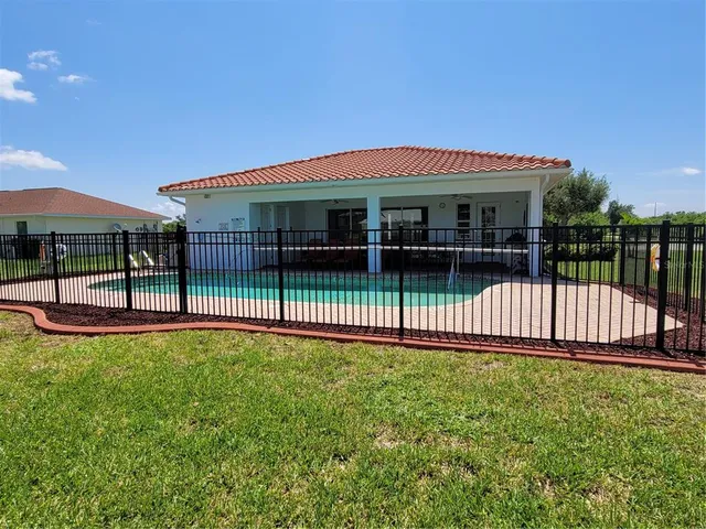 a view of a house with a deck and a yard