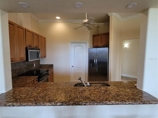 a kitchen with sink and refrigerator