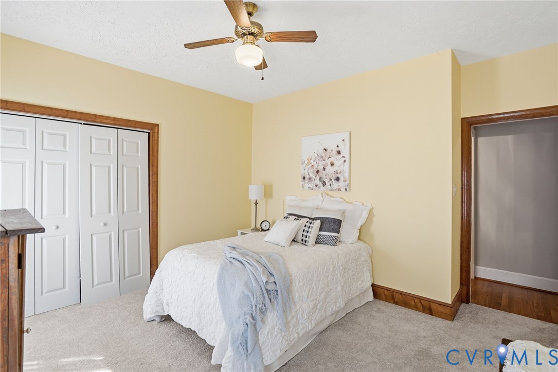 12123 Deer Ridge Court Ashland, VA 23005 - Photo 26 of 63 a bedroom with a bed and a chandelier