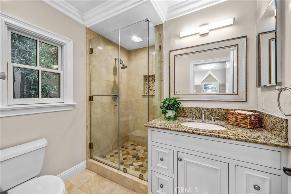 1665 Lorain Road San Marino, CA 91108 - Photo 21 of 45 a bathroom with a granite countertop sink a mirror a vanity and shower