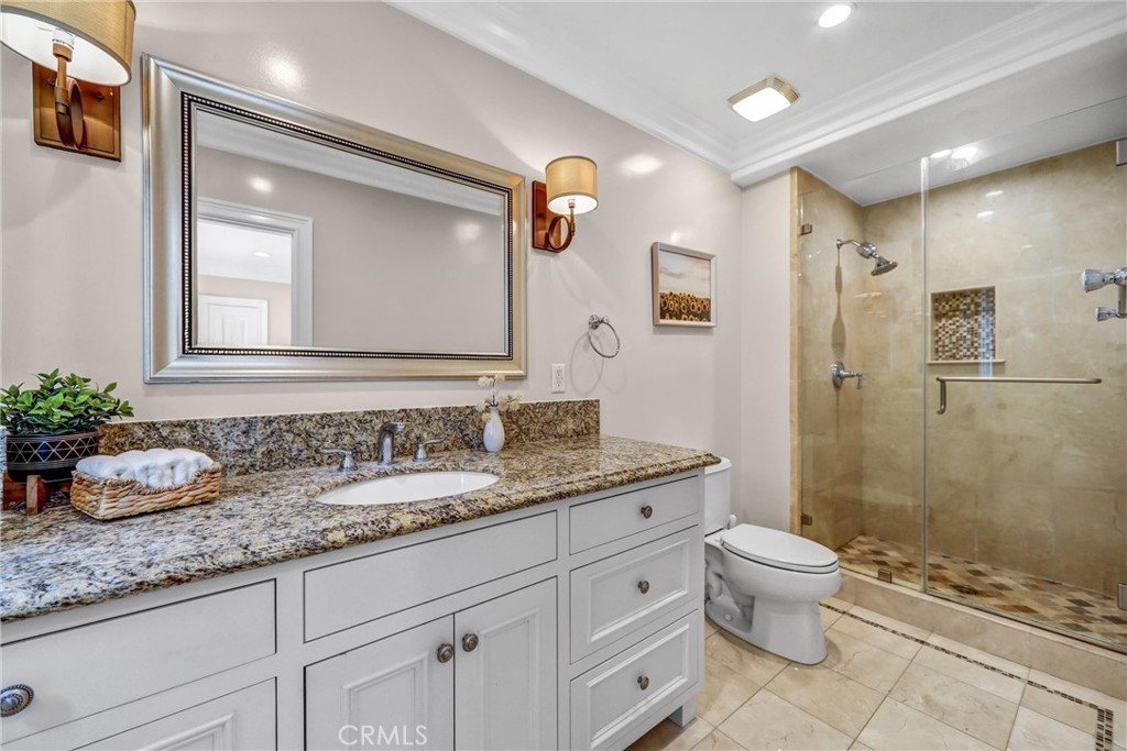 1665 Lorain Road San Marino, CA 91108 - Photo 29 of 45 a bathroom with a granite countertop sink a toilet and shower