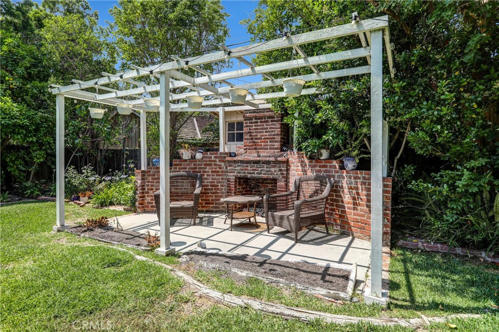 1665 Lorain Road San Marino, CA 91108 - Photo 39 of 45 a view of patio with table and chairs under an umbrella with a small yard