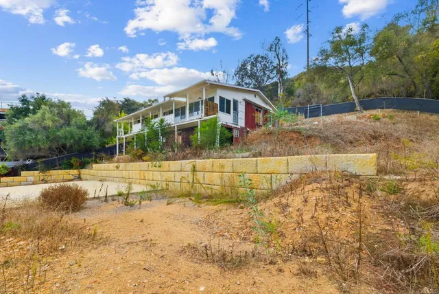 a view of yard with swimming pool and sitting area