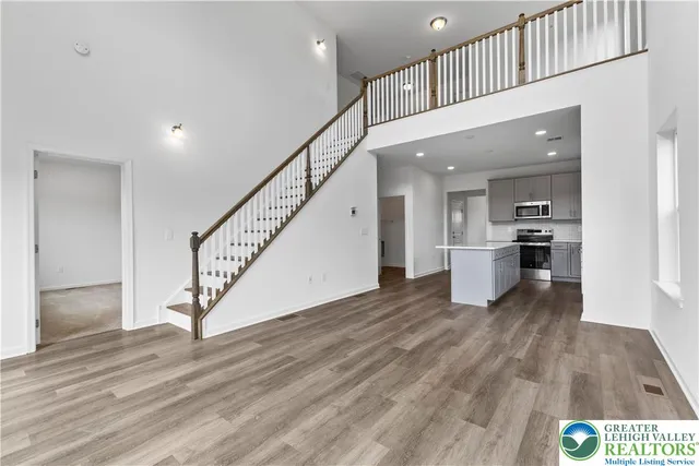 a view of kitchen with wooden floor and electronic appliances