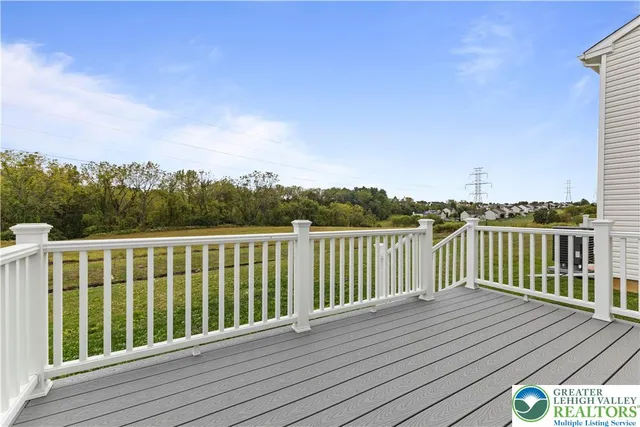 a view of balcony with wooden floor and fence