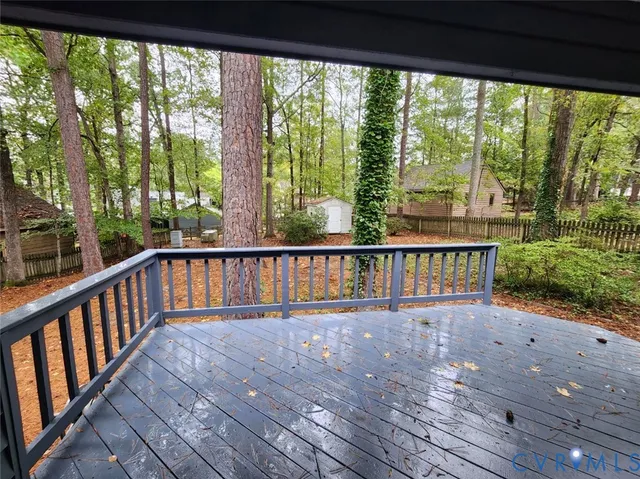 a view of a wooden balcony with outdoor space
