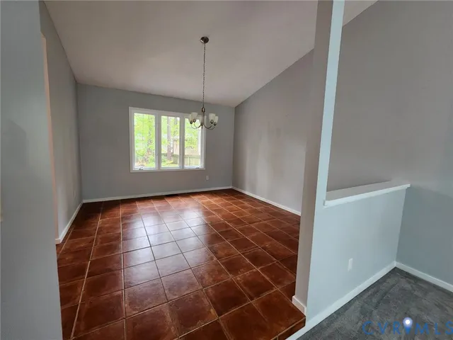 an empty room with windows and entrance