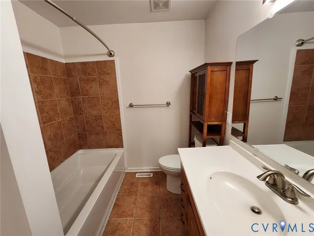 a bathroom with a tub and a sink