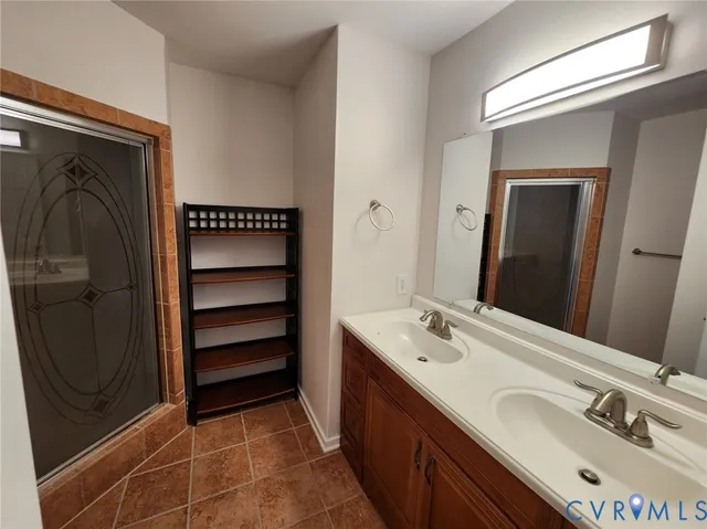 a bathroom with a double vanity sink and a mirror