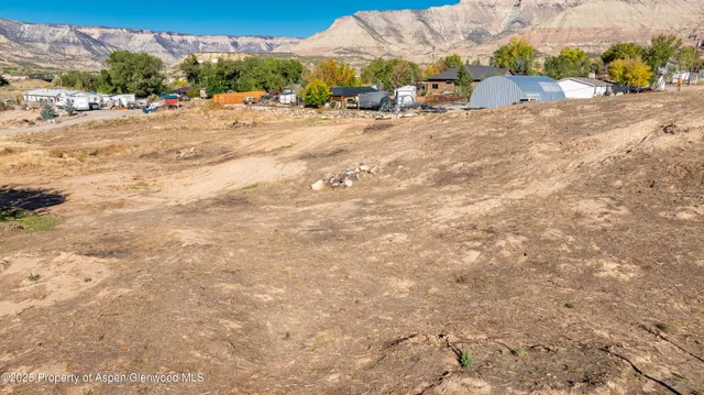 a view of dirt road with a building in the background