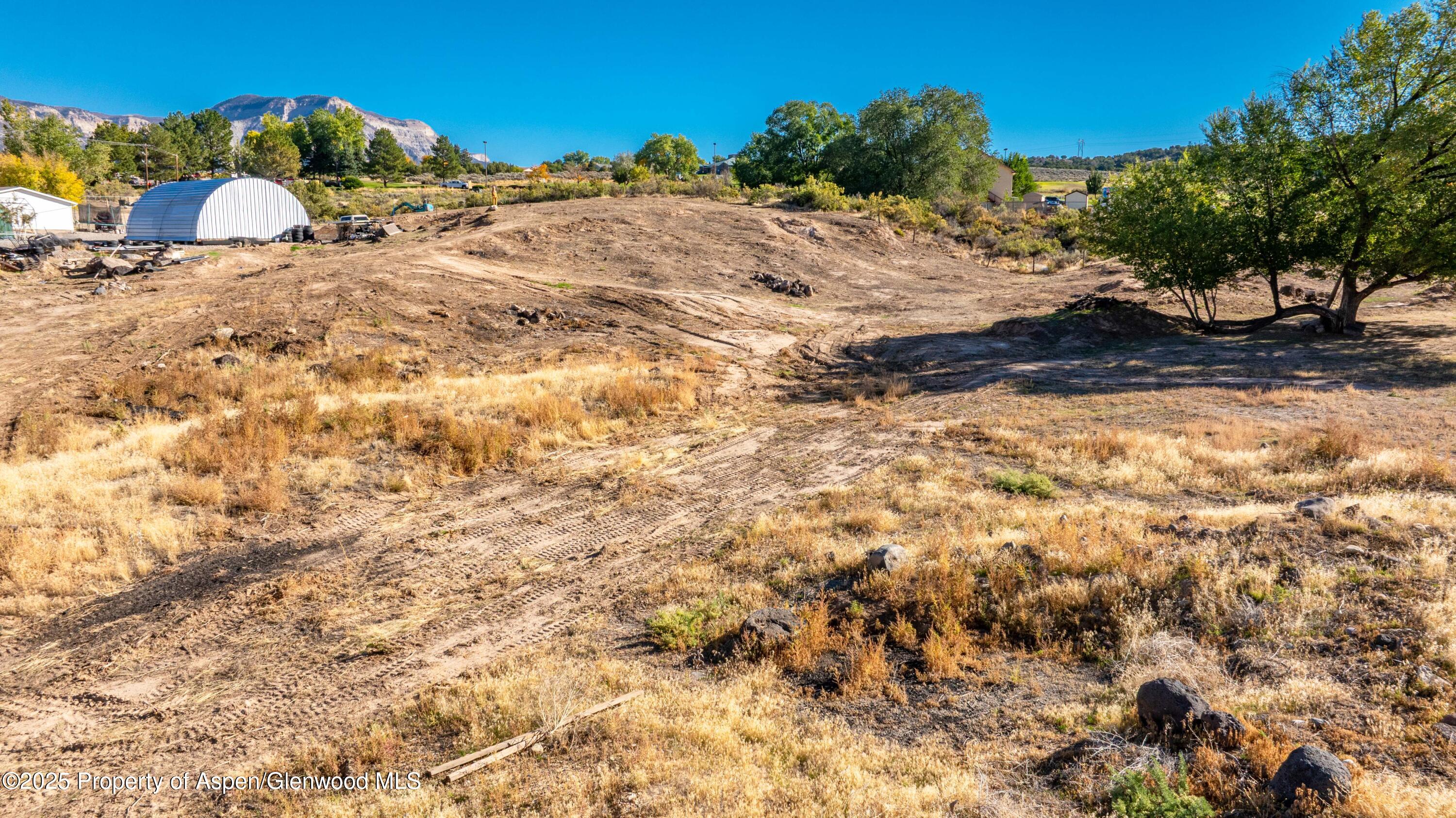 305 Parachute Co 81635 Parachute, CO 81635 - Photo 7 of 10 a view of a dry yard with wooden fence
