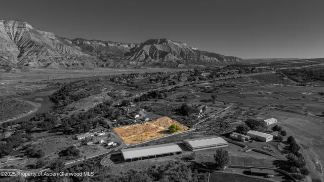 a view of a parking space with wooden fence