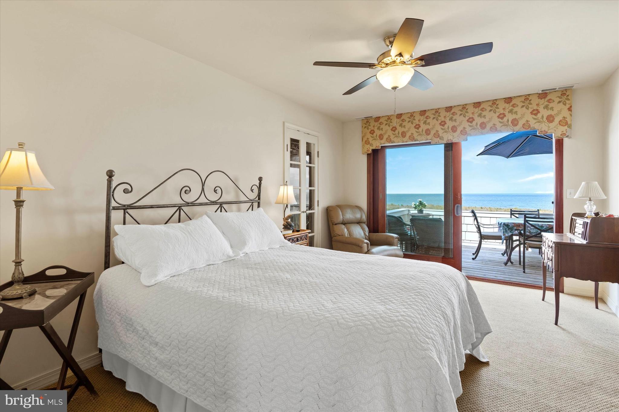 10 Pilot Point, Unit 10B Lewes, DE 19958 - Photo 17 of 38 a bedroom with a large bed and a chandelier