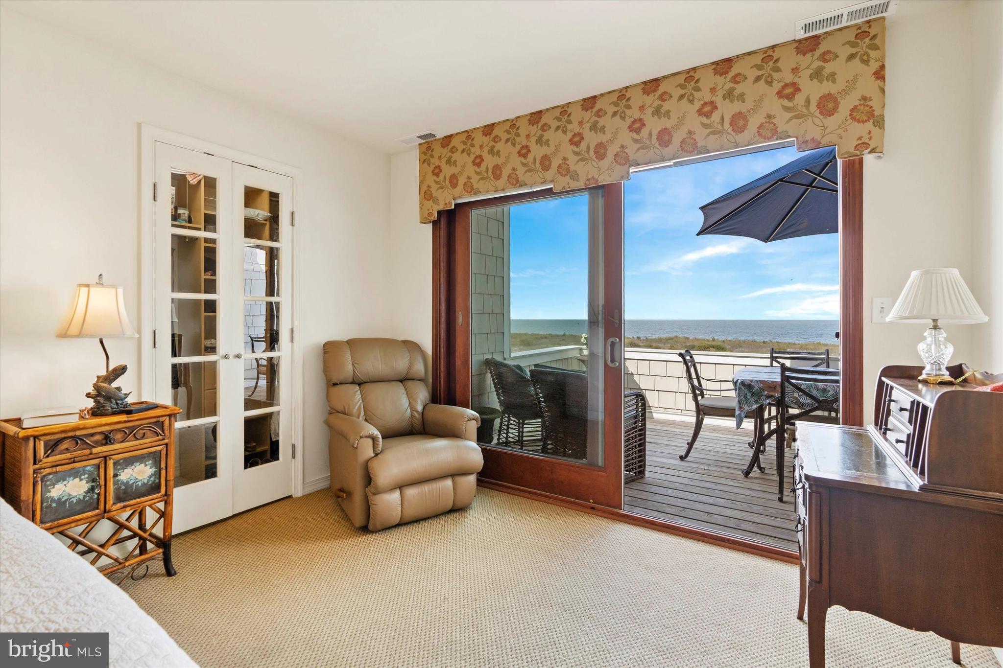 10 Pilot Point, Unit 10B Lewes, DE 19958 - Photo 19 of 38 a living room with furniture and a floor to ceiling window