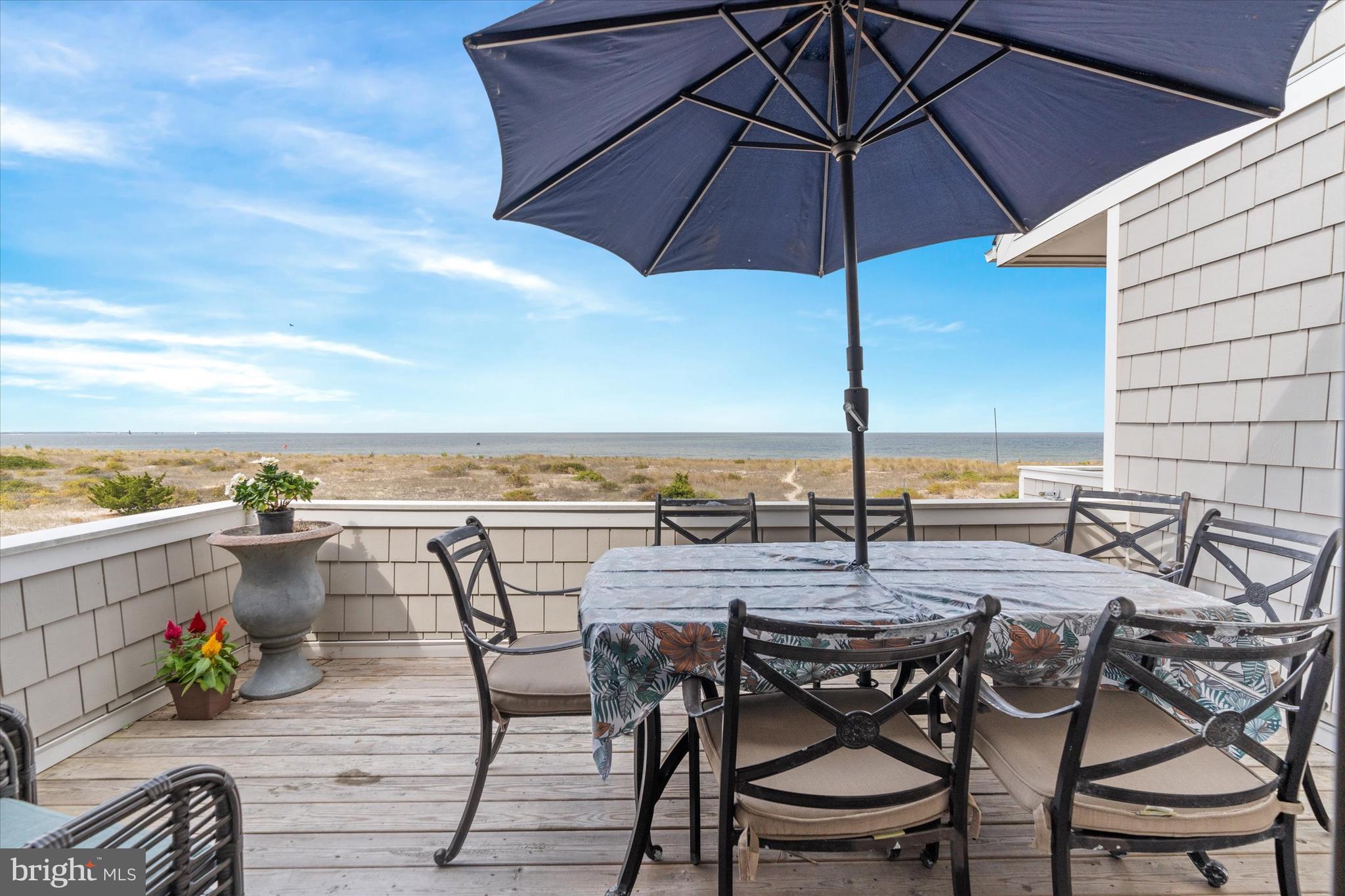 10 Pilot Point, Unit 10B Lewes, DE 19958 - Photo 20 of 38 a view of a terrace with furniture and umbrella