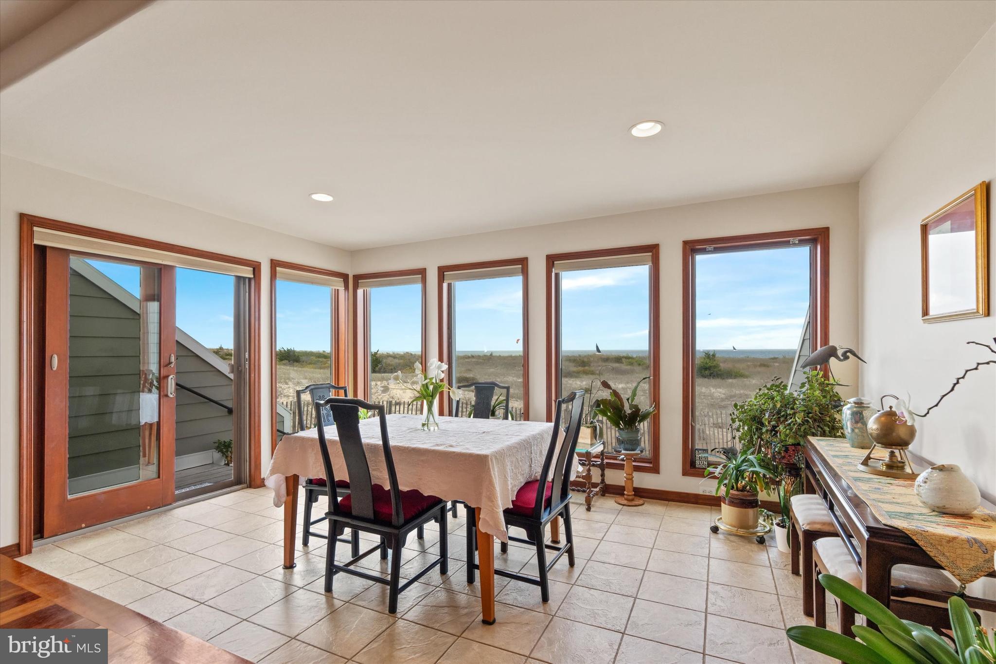 10 Pilot Point, Unit 10B Lewes, DE 19958 - Photo 7 of 38 a view of a dining room with furniture large windows and wooden floor