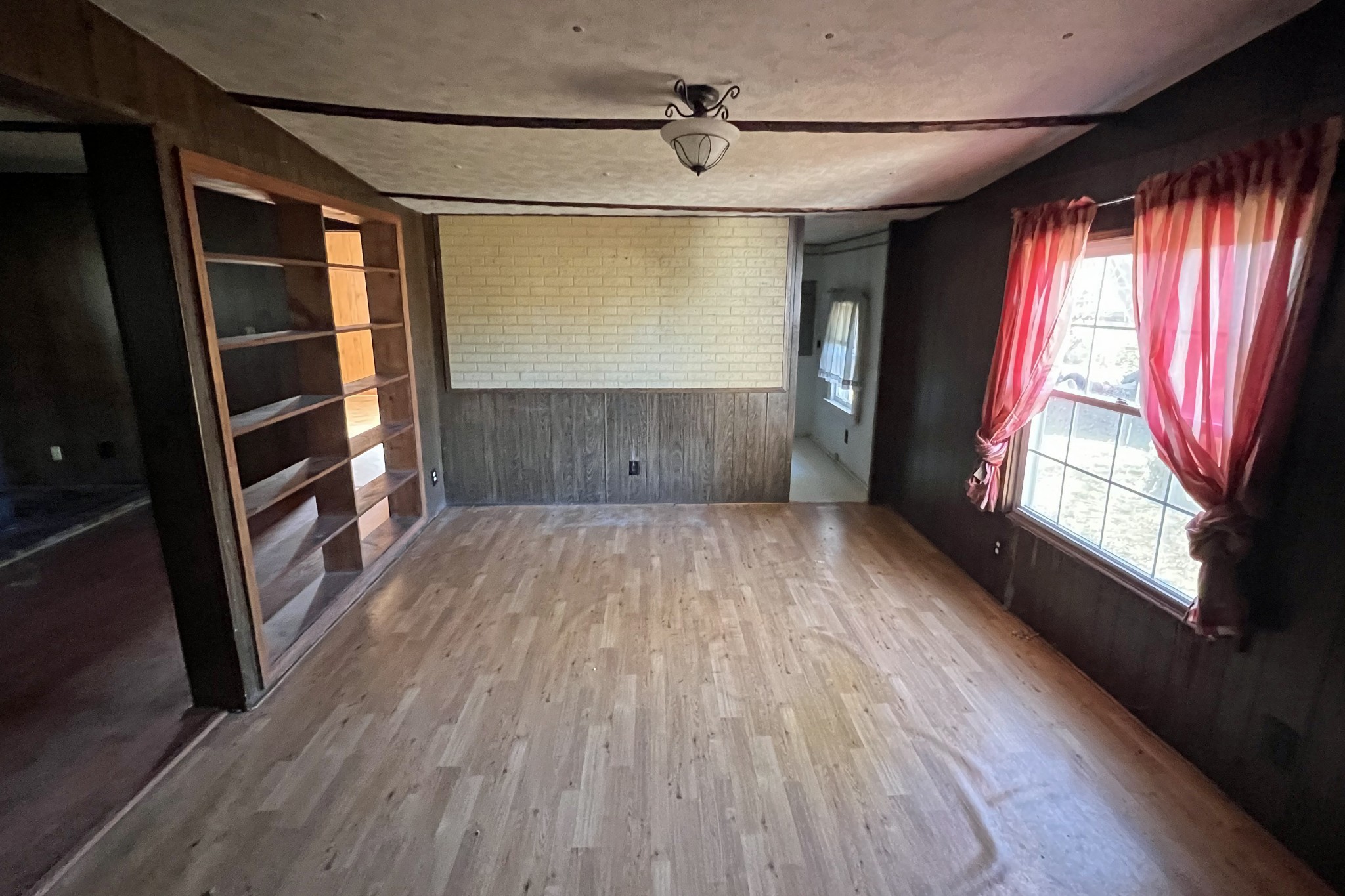 709 Calvert Road Adolphus, KY 42120 - Photo 3 of 19 a view of empty room with wooden floor and fan