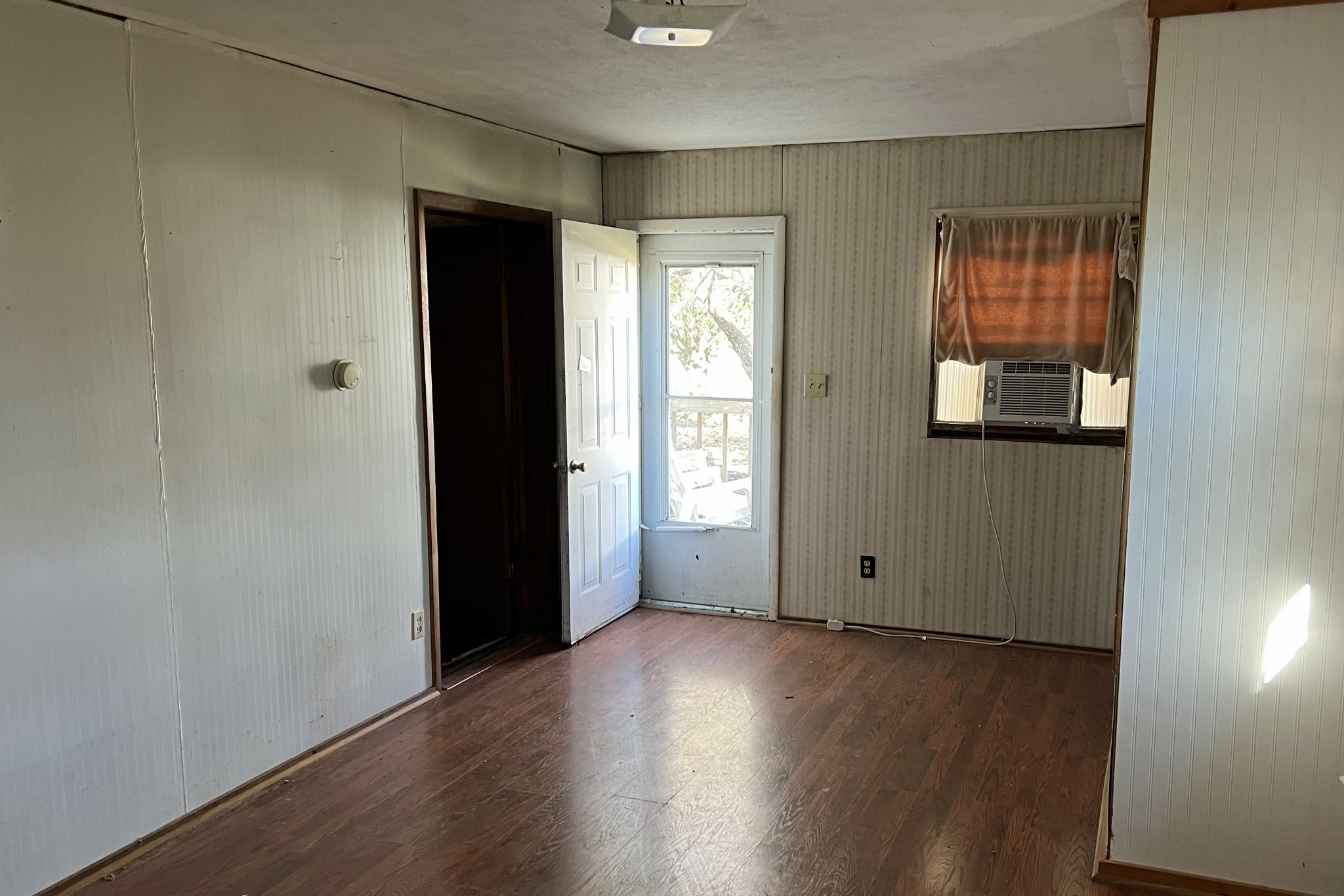 709 Calvert Road Adolphus, KY 42120 - Photo 8 of 19 an empty room with wooden floor and windows