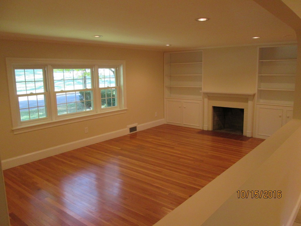 40 Highland Terrace Taunton, MA 02780 - Photo 15 of 29 an empty room with wooden floor fireplace and windows