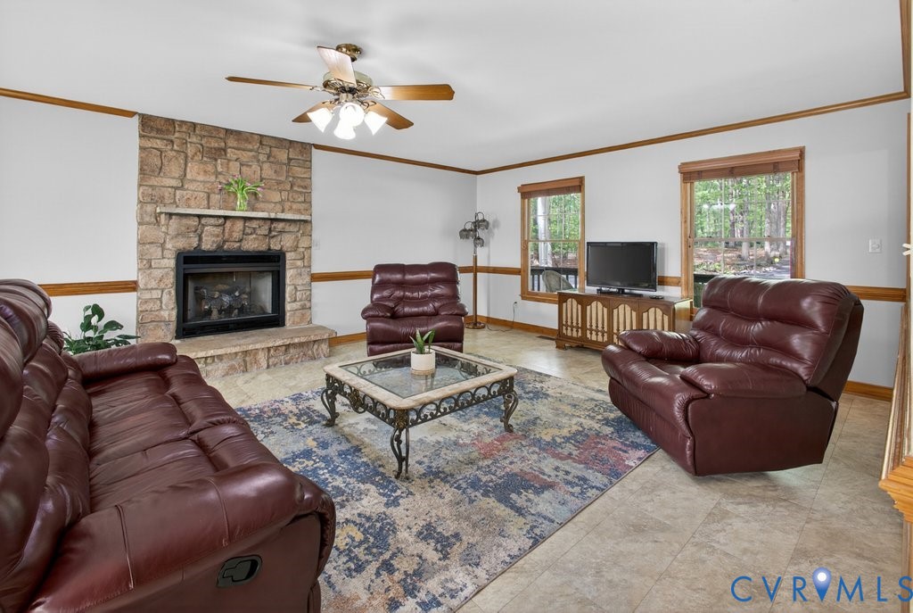 173 Covenant Way Bumpass, VA 23024 - Photo 22 of 63 Living room featuring a stone fireplace with a hea