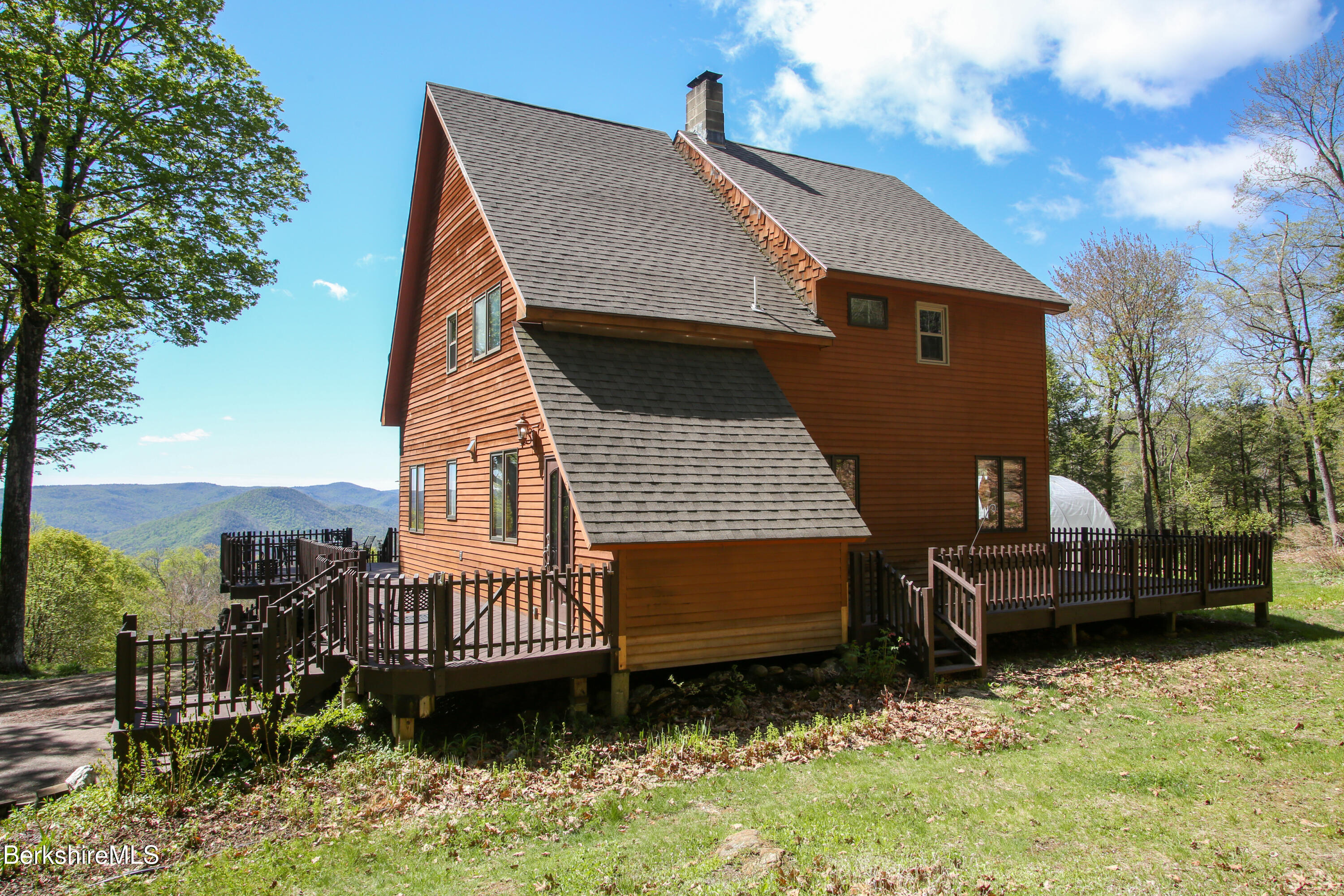 421 Legate Hill Road Charlemont, MA 01339 - Photo 3 of 37 a view of a house with a wooden deck and furniture