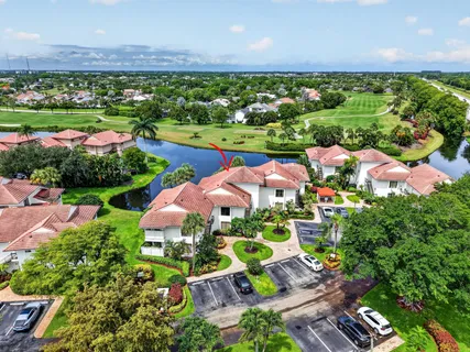 an aerial view of residential houses with outdoor space and swimming pool