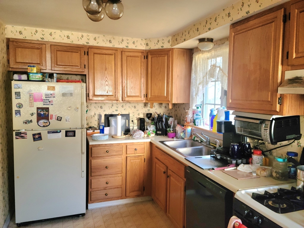 17 Harvard Street Natick, MA 01760 - Photo 7 of 12 a kitchen with refrigerator and cabinets
