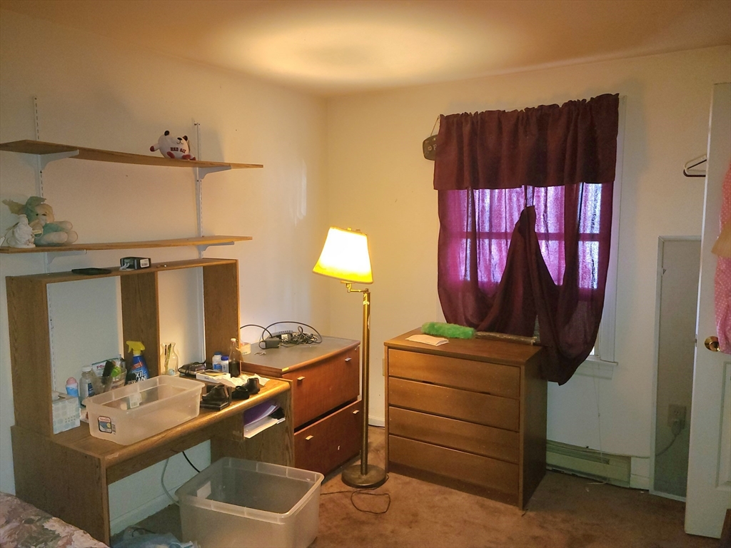 17 Harvard Street Natick, MA 01760 - Photo 10 of 12 a room with a bed and a mirror