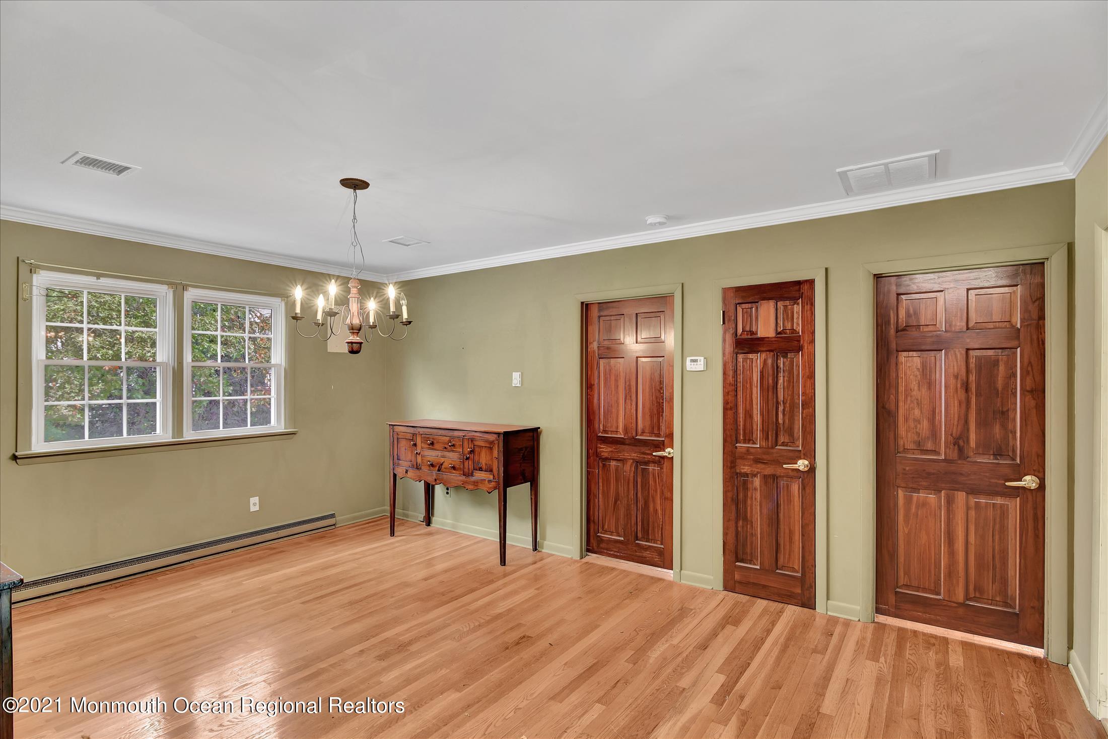 149 Crine Road Morganville, NJ 07751 - Photo 15 of 28 a big room with wooden floor and windows