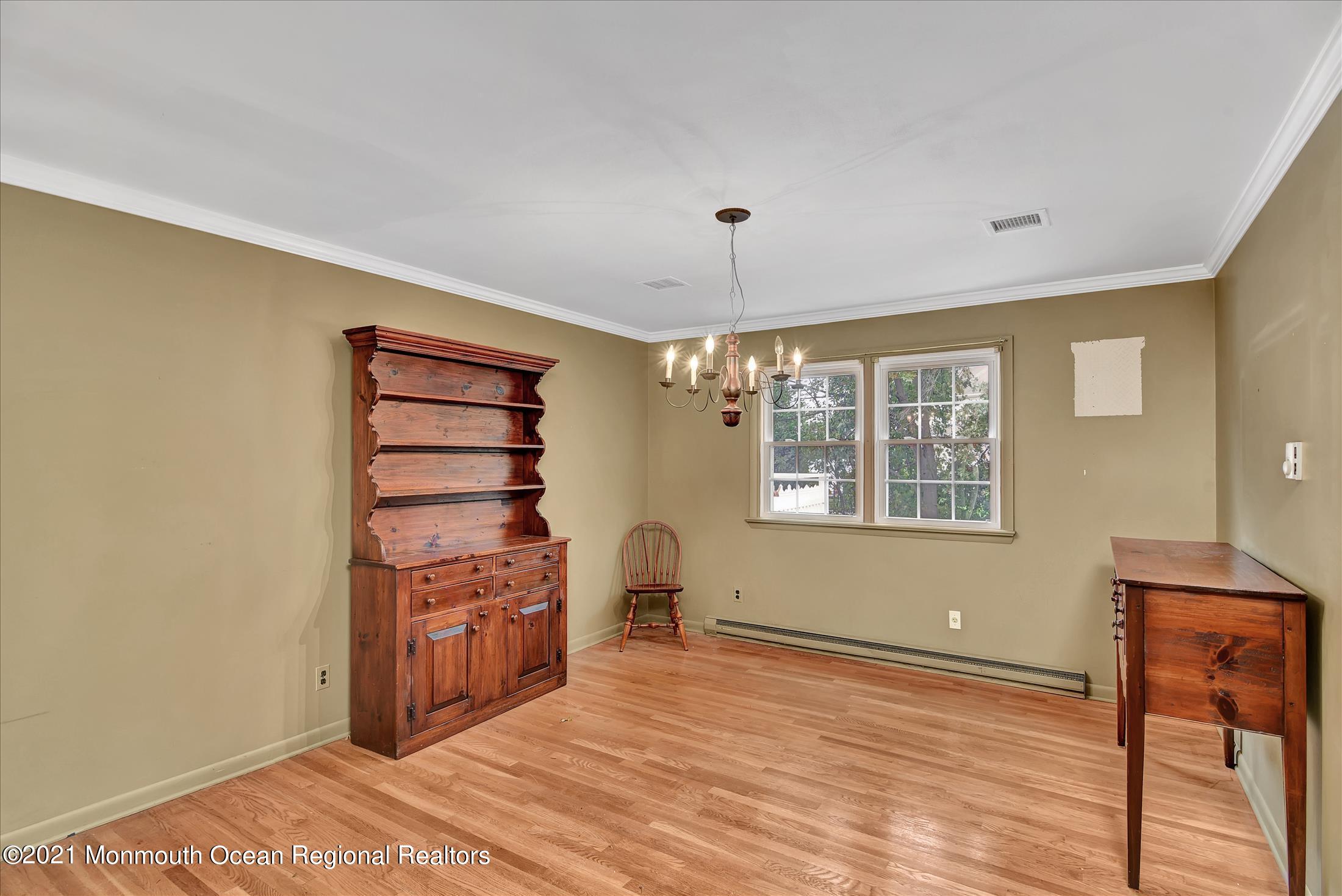 149 Crine Road Morganville, NJ 07751 - Photo 16 of 28 a view of a bedroom with a window and a ceiling fan