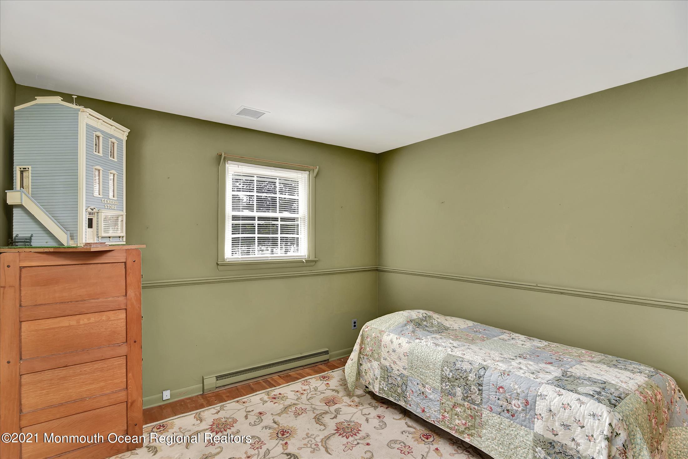 149 Crine Road Morganville, NJ 07751 - Photo 21 of 28 a bedroom with a bed and a window