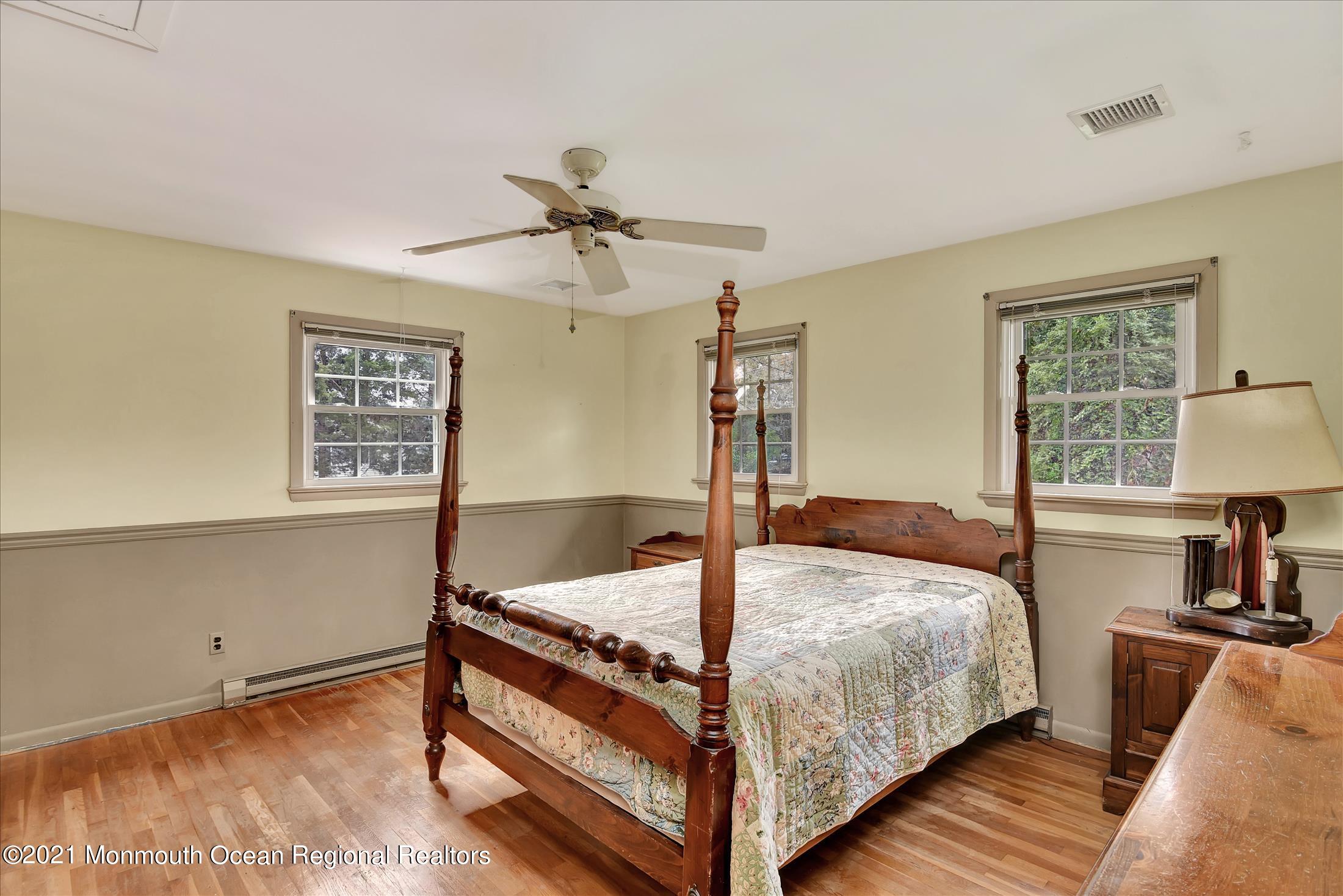 149 Crine Road Morganville, NJ 07751 - Photo 23 of 28 a bedroom with a bed and a window