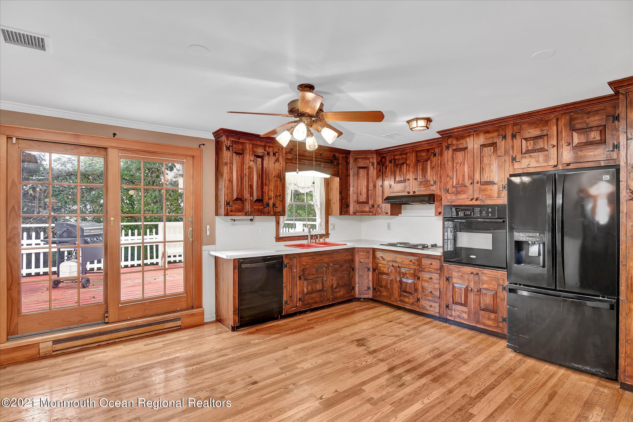 149 Crine Road Morganville, NJ 07751 - Photo 4 of 28 a kitchen with stainless steel appliances granite countertop a refrigerator oven a sink dishwasher and a stove with wooden floor