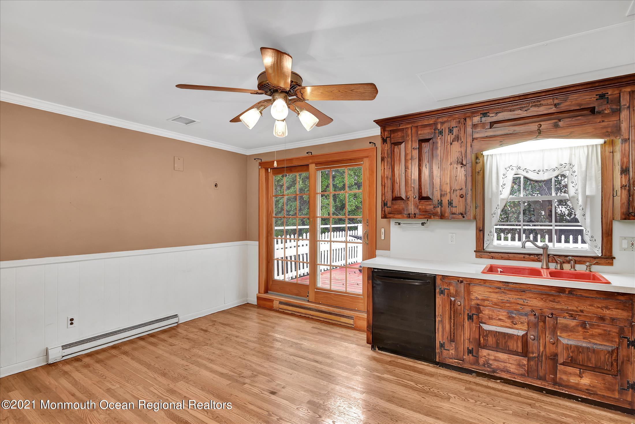 149 Crine Road Morganville, NJ 07751 - Photo 5 of 28 a view of a kitchen with stainless steel appliances wooden floor and a large window
