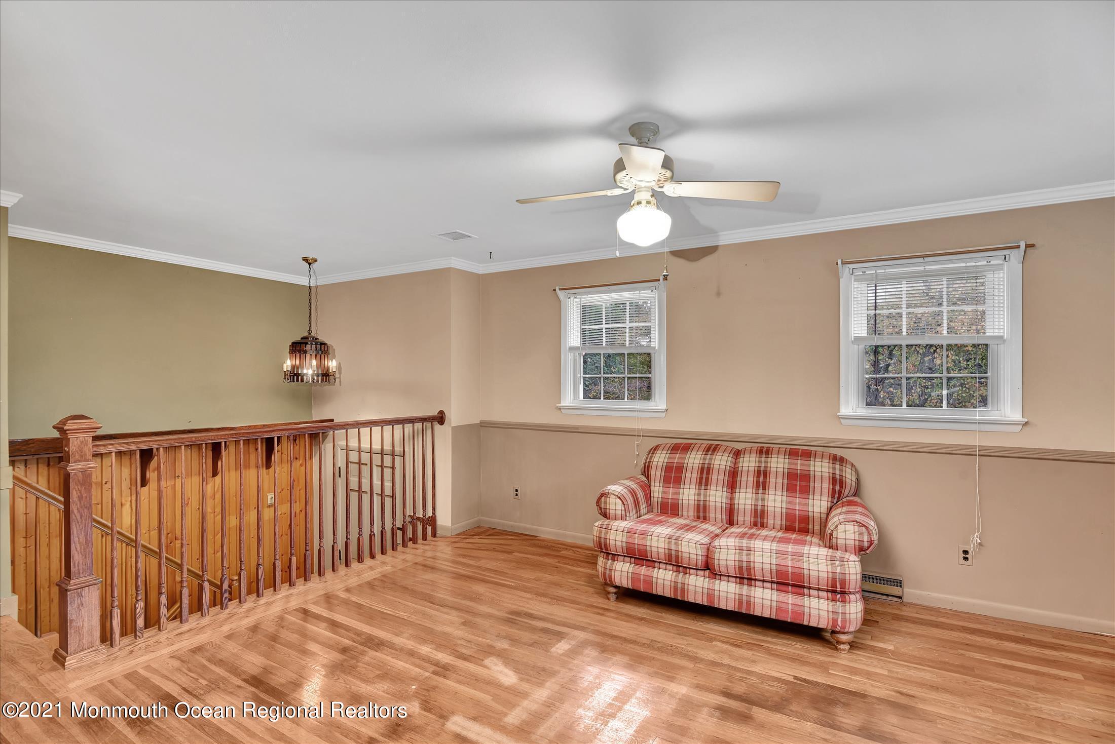 149 Crine Road Morganville, NJ 07751 - Photo 10 of 28 a bedroom with furniture and a window