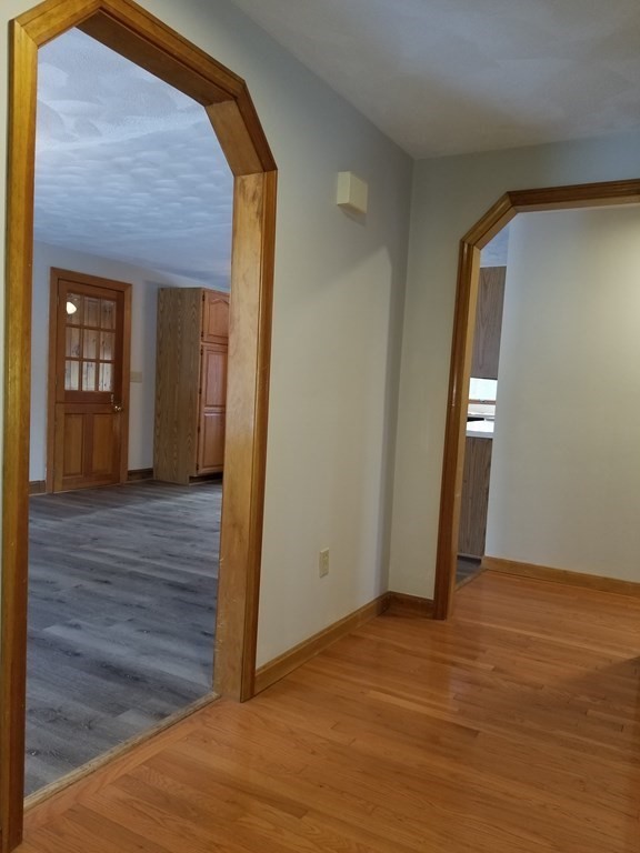 22 Whitney Road Shirley, MA 01464 - Photo 4 of 42 a view of an empty room with wooden floor and a window