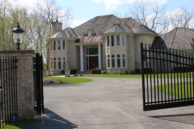 195 Bateman Road Barrington Hills, IL 60010 - Photo 23 of 23 a view of a white house with a small yard and large trees