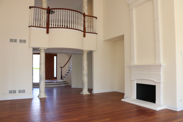 195 Bateman Road Barrington Hills, IL 60010 - Photo 8 of 23 a view of staircase with white walls and fireplace