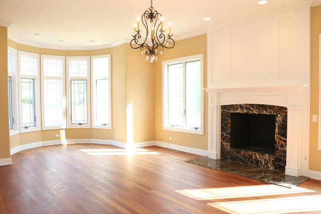 195 Bateman Road Barrington Hills, IL 60010 - Photo 10 of 23 a view of an empty room with wooden floor and a fireplace