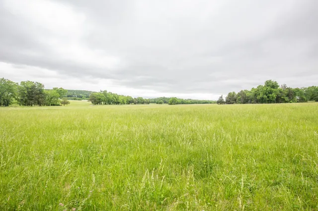 an aerial view of a golf course with a lake view