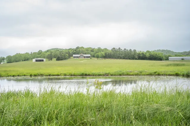 a view of a lake with houses in the back