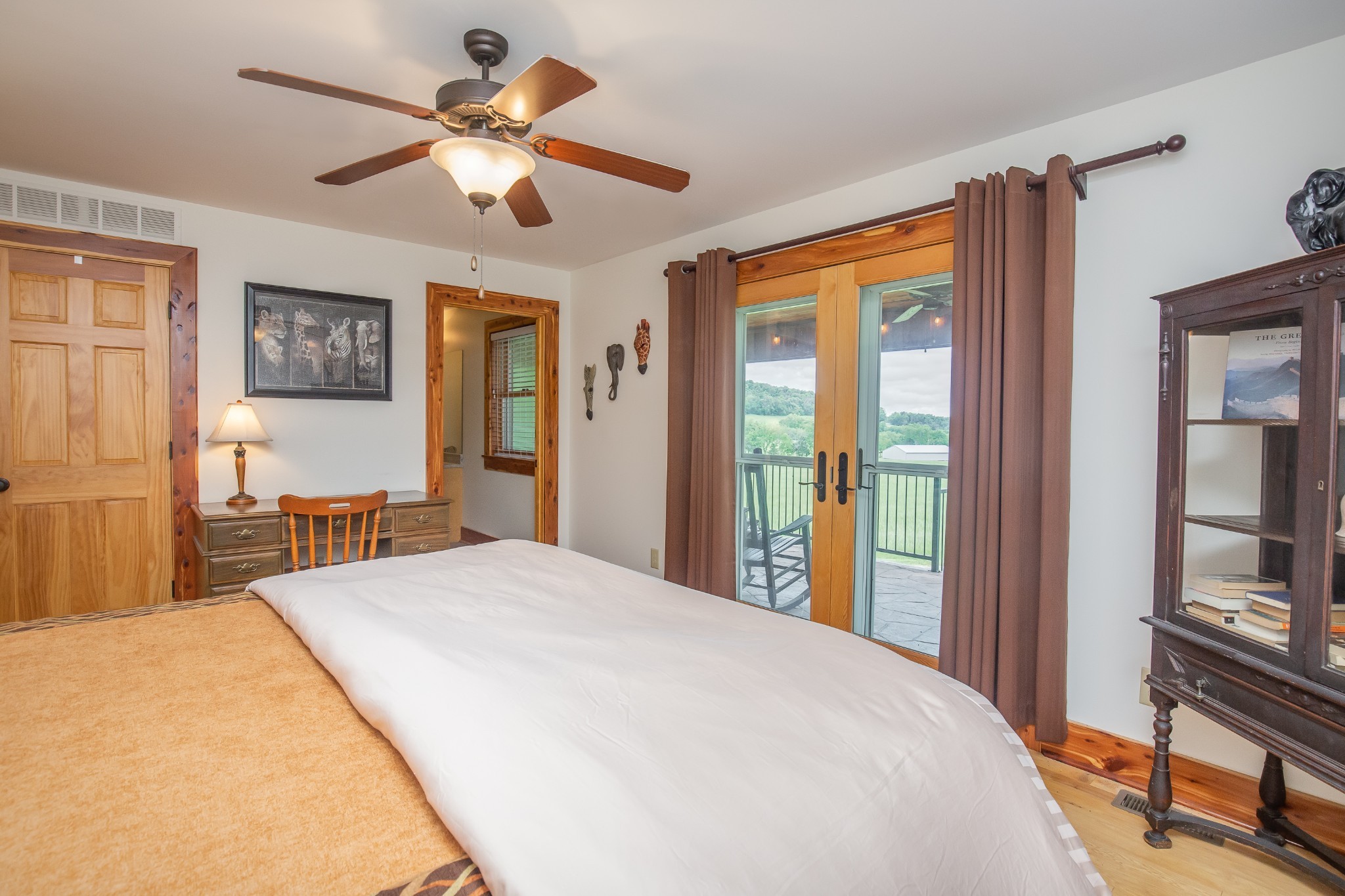 521 Coop Road Bell Buckle, TN 37020 - Photo 47 of 63 a bedroom with a large bed and a chandelier