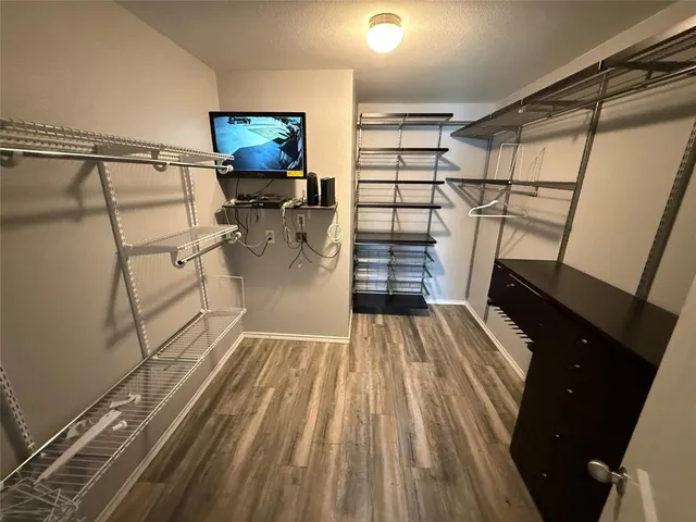 a view of a room with wooden floor