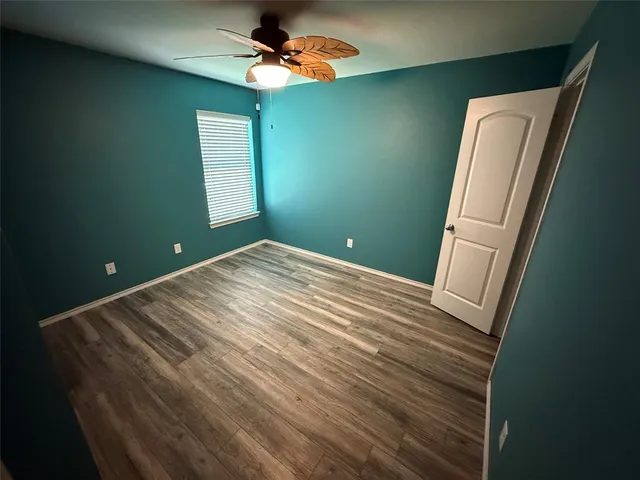 a view of a room that has a bed and a window