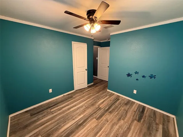a view of a livingroom with a chandelier fan and a large window